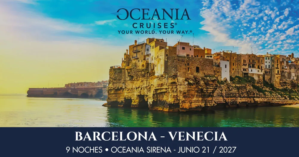 Paisaje costero del Mediterráneo con casas históricas sobre un acantilado, representando un crucero de 9 noches a bordo del Oceania Sirena desde Barcelona hasta Venecia en junio de 2027.